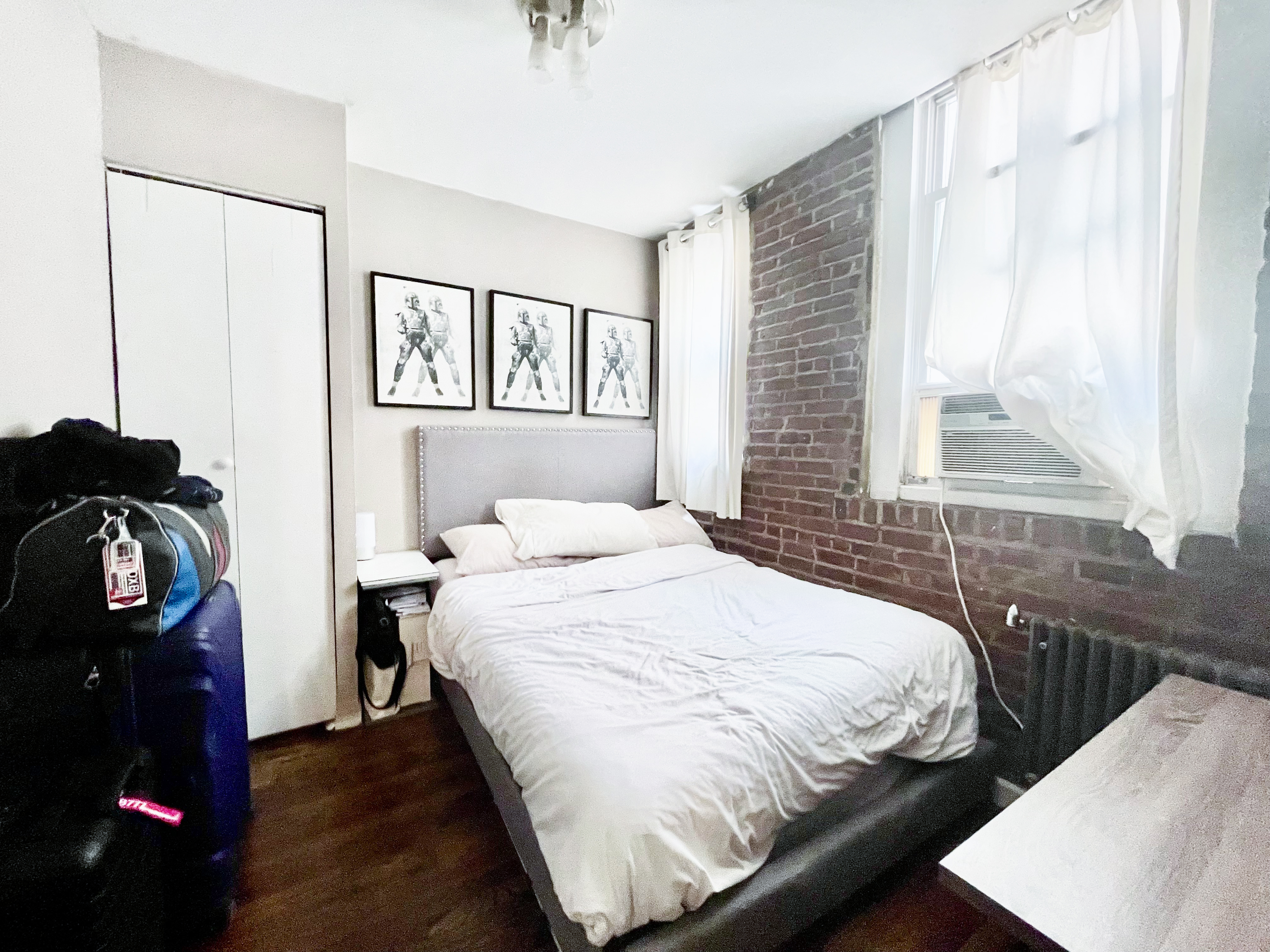 57 Spring Street, Unit 6 Manhattan, NY 10012 - Photo 6 of 10 a bedroom with a bed and a window
