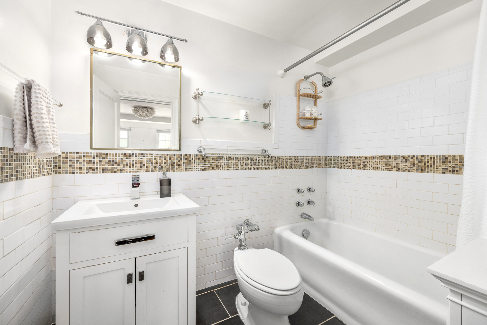 45 Christopher Street, Unit 3C Manhattan, NY 10014 - Photo 9 of 11 a bathroom with a sink toilet vanity and bathtub