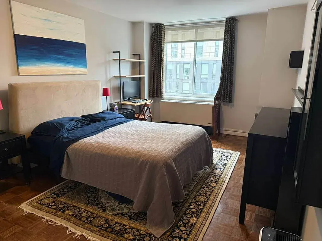 a bedroom with a bed and a window