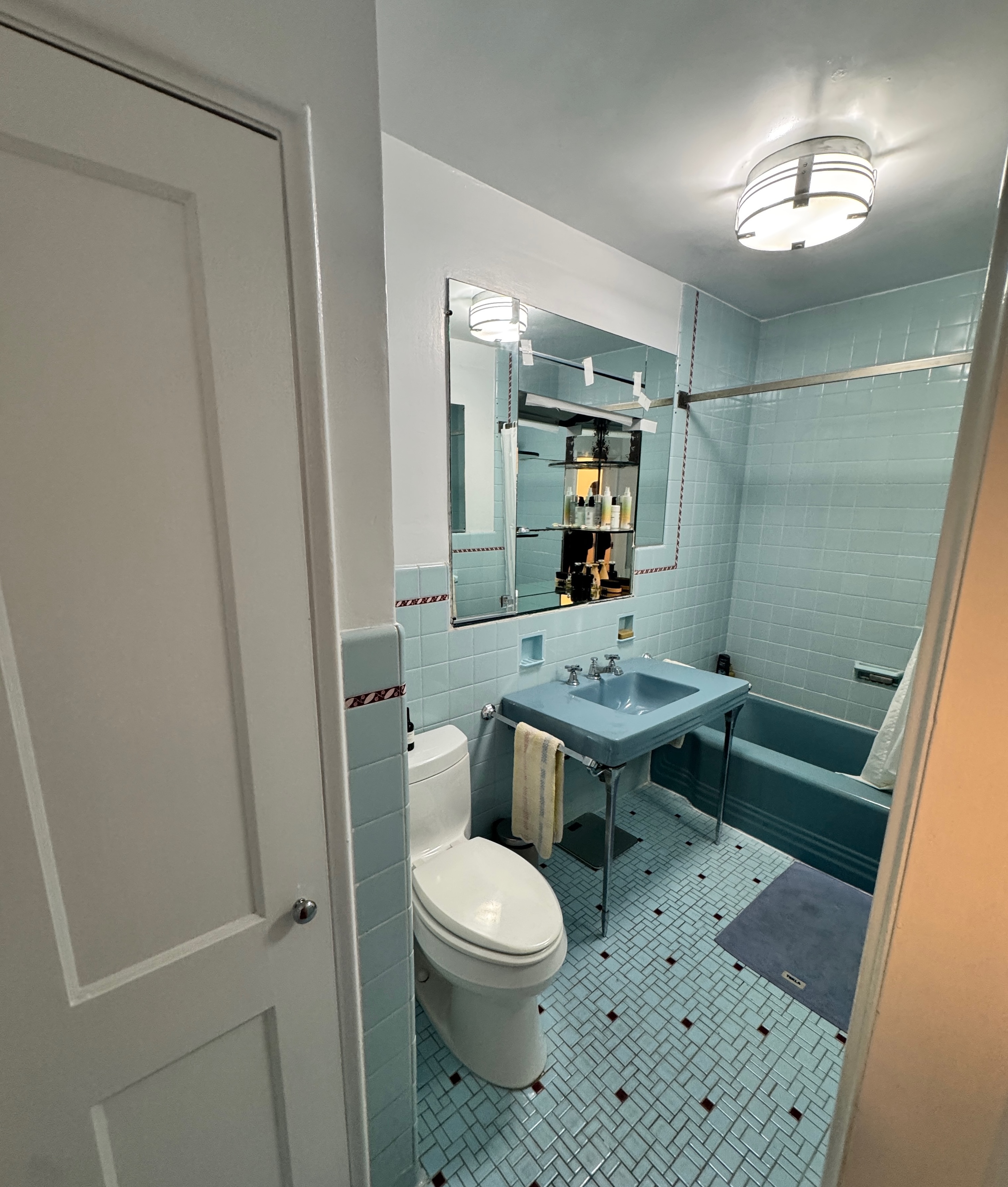 19 Vandam Street, Unit 2 Manhattan, NY 10014 - Photo 14 of 19 a bathroom with a toilet a sink and a mirror