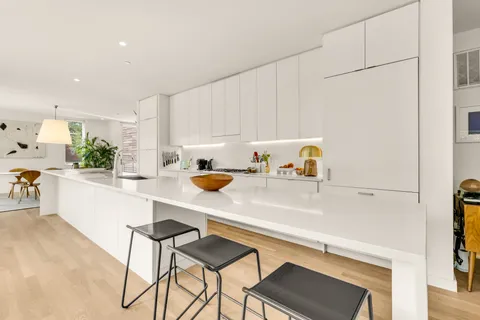a kitchen with a sink cabinets and white appliances