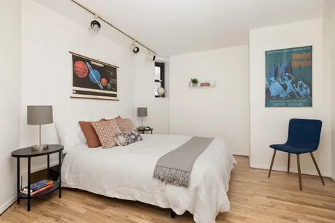 a bedroom with a bed and a chair