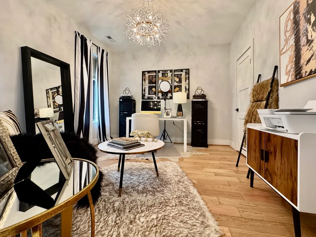 a living room with furniture a fireplace and a chandelier
