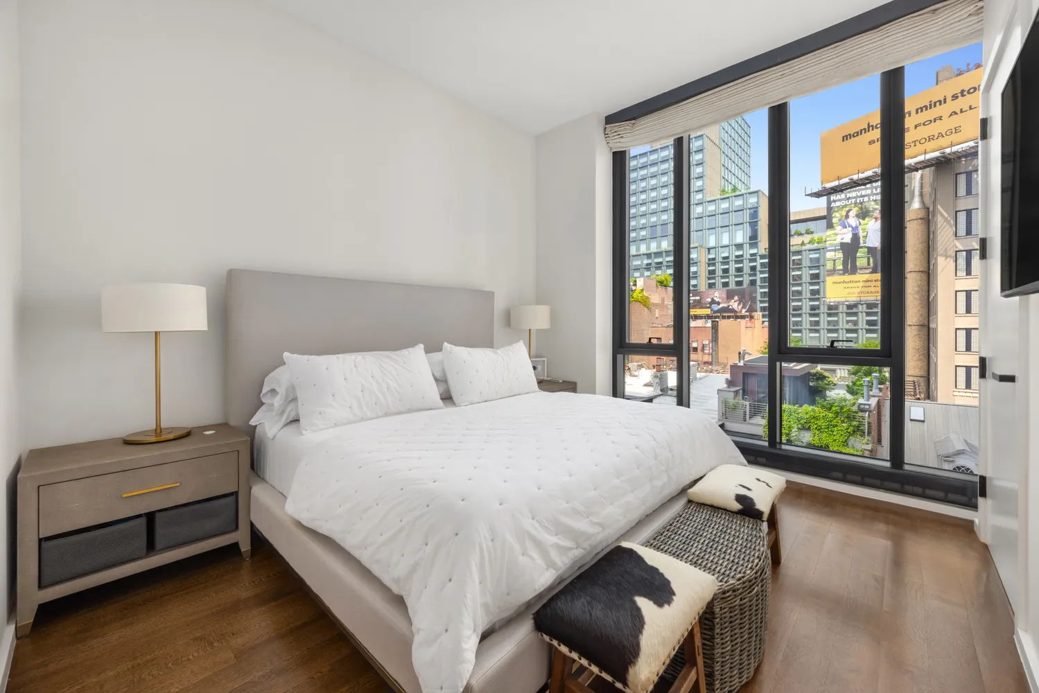 a bedroom with a bed and a large window