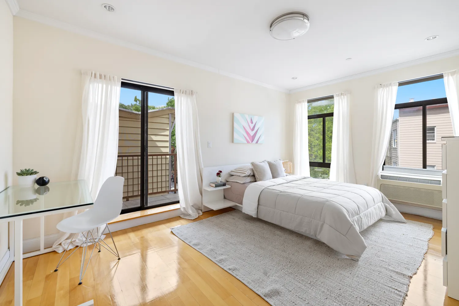 a bedroom with a bed and a large window