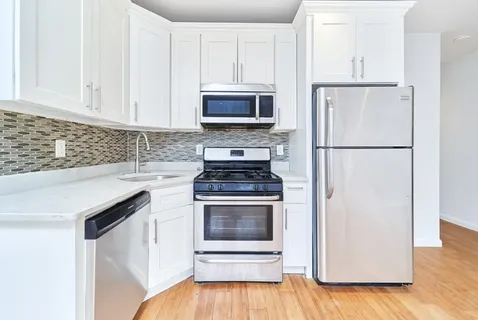 a kitchen with a refrigerator and a stove