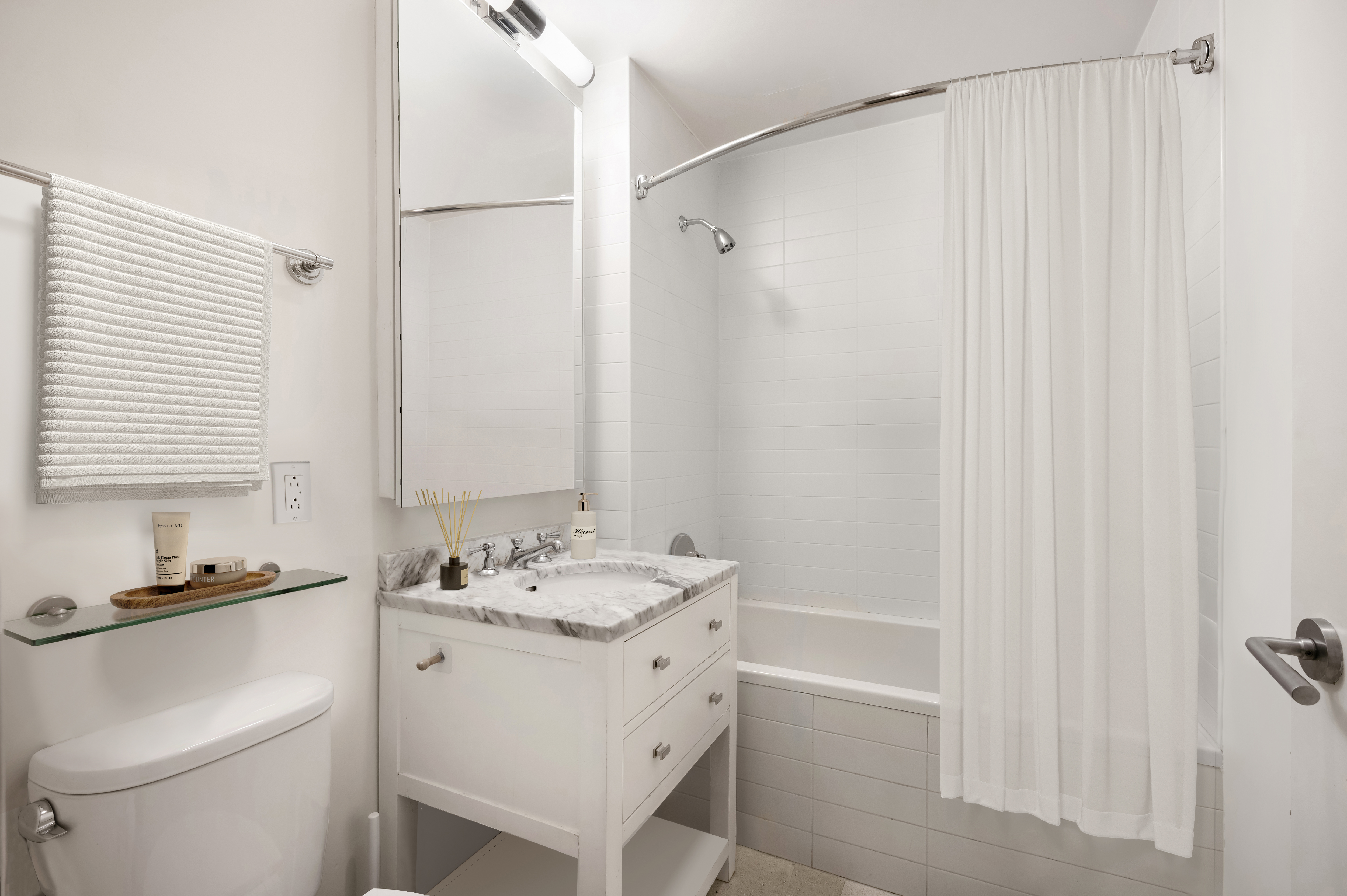 125 West 22nd Street, Unit 8B Manhattan, NY 10011 - Photo 7 of 10 a bathroom with a sink a toilet and shower