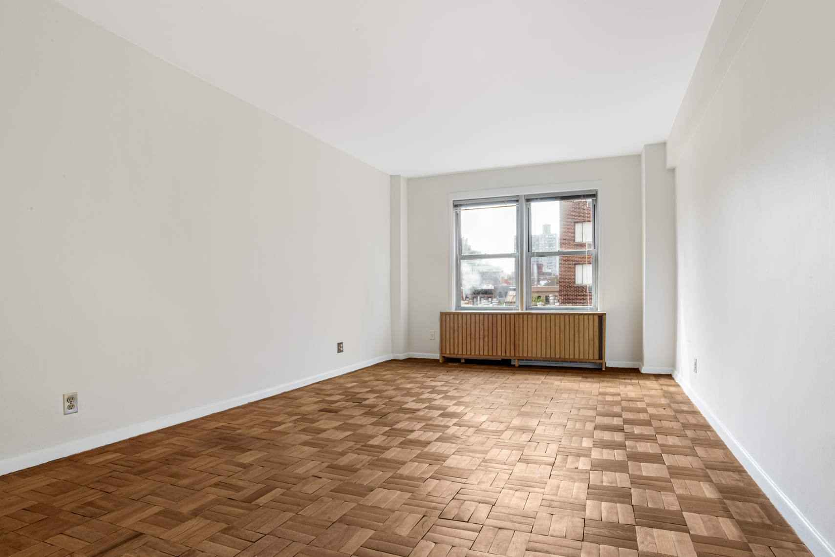 515 East 85th Street, Unit 8C Manhattan, NY 10028 - Photo 4 of 10 a view of an empty room and window