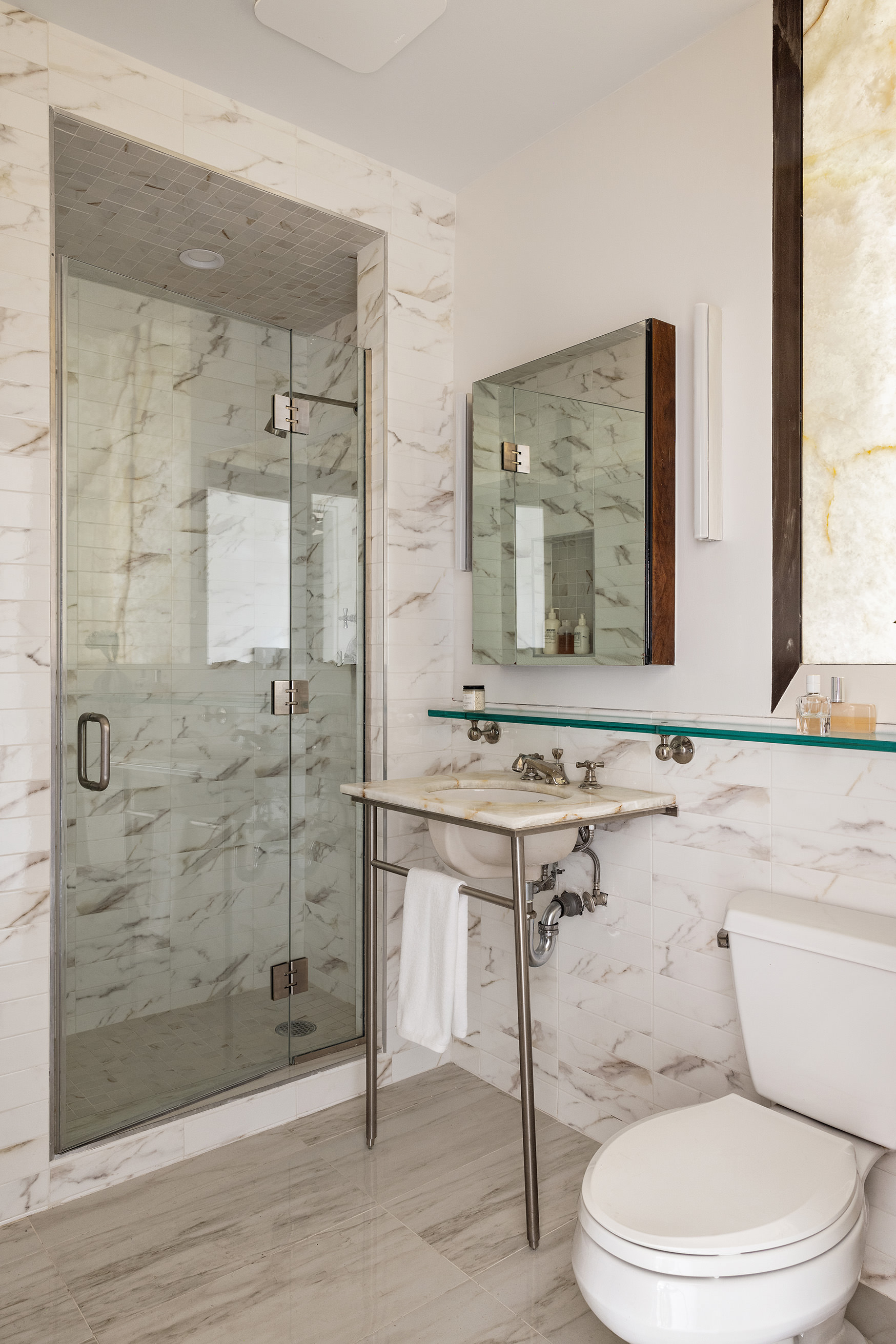 169 Mercer Street, Unit PH Manhattan, NY 10012 - Photo 12 of 15 a bathroom with a sink a toilet and shower