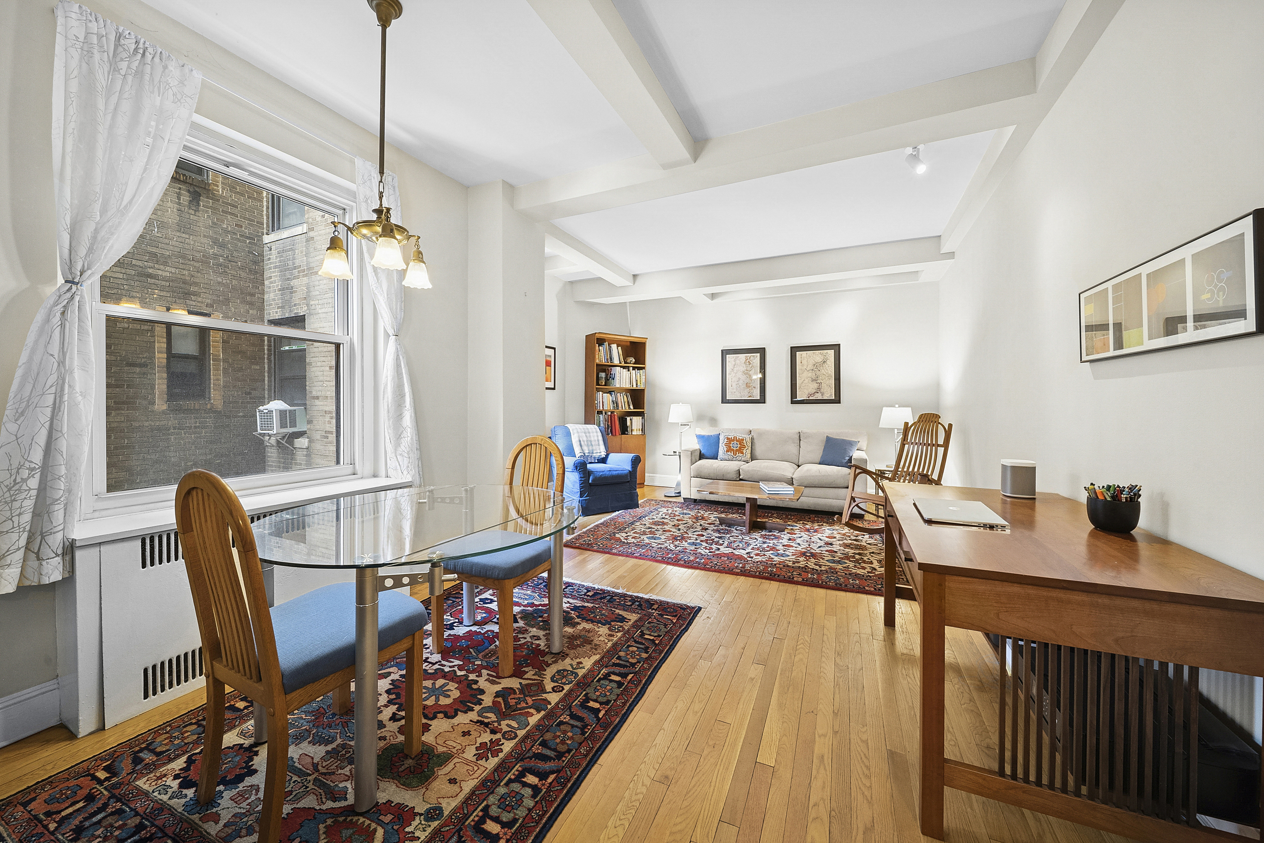 263 West End Avenue, Unit 9E Manhattan, NY 10023 - Photo 1 of 10 a living room with furniture and a table