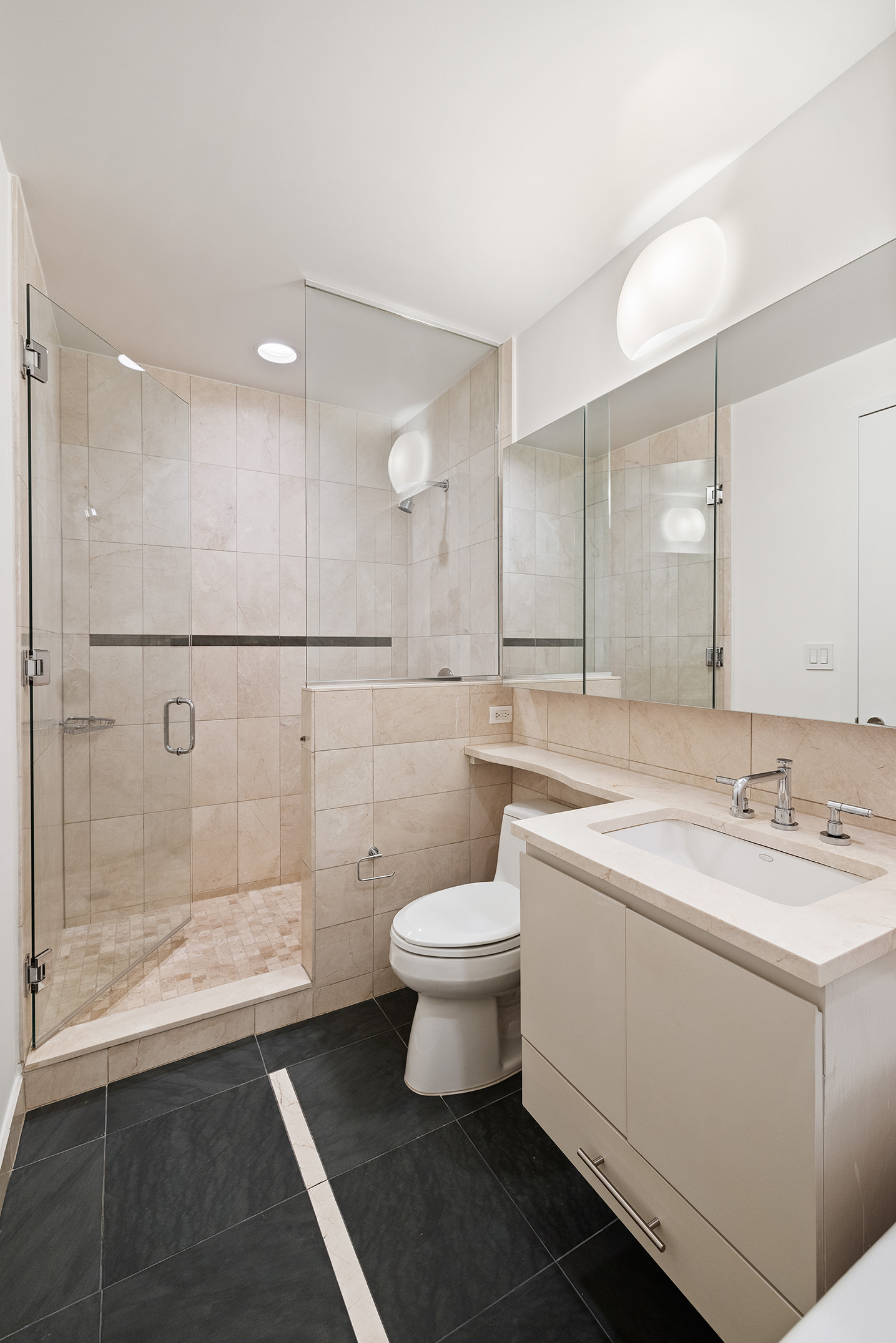 255 Hudson Street, Unit 7C Manhattan, NY 10013 - Photo 7 of 9 a bathroom with a sink toilet and shower