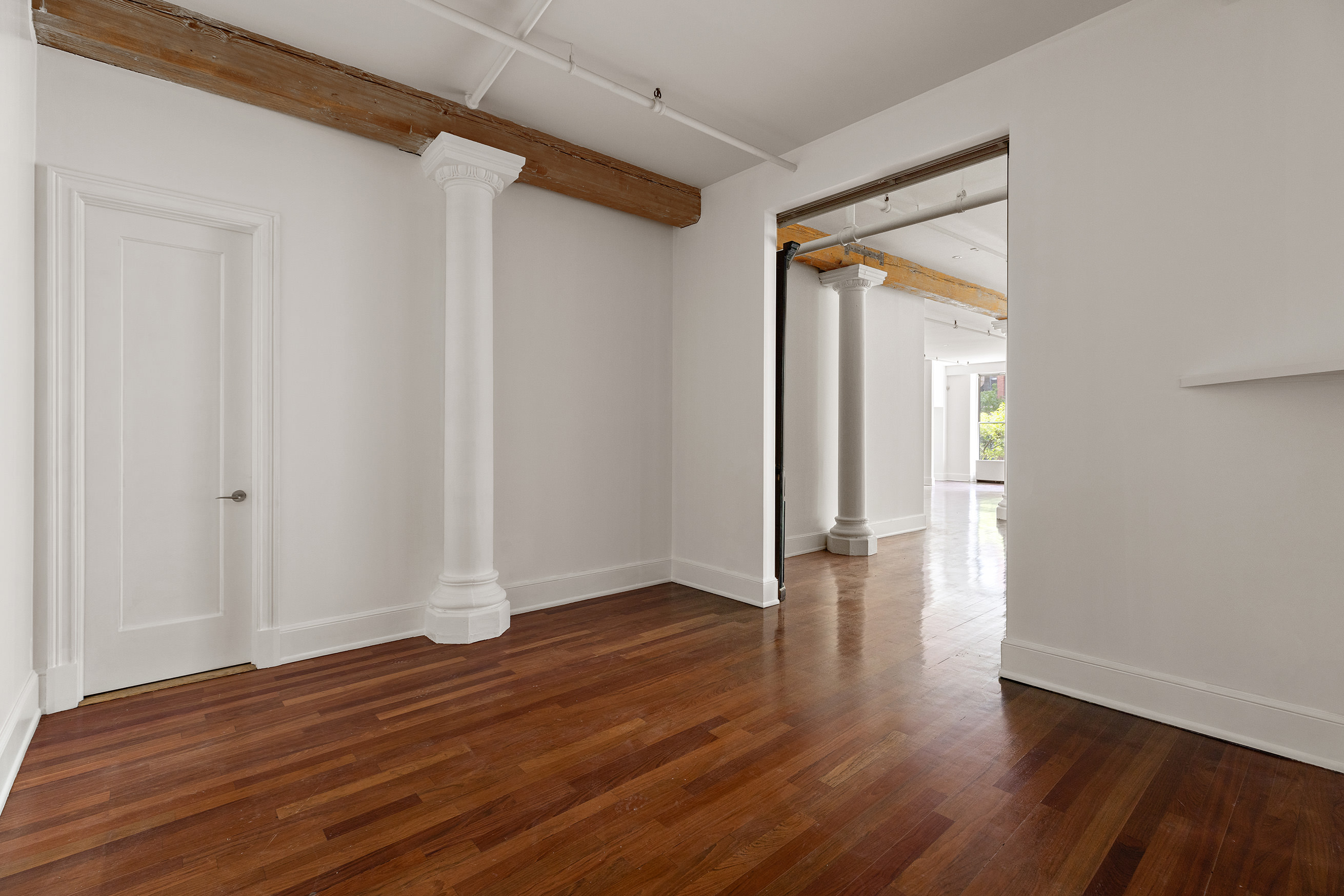 285 Lafayette Street, Unit 2B Manhattan, NY 10012 - Photo 14 of 19 a view of an empty room with wooden floor and a window