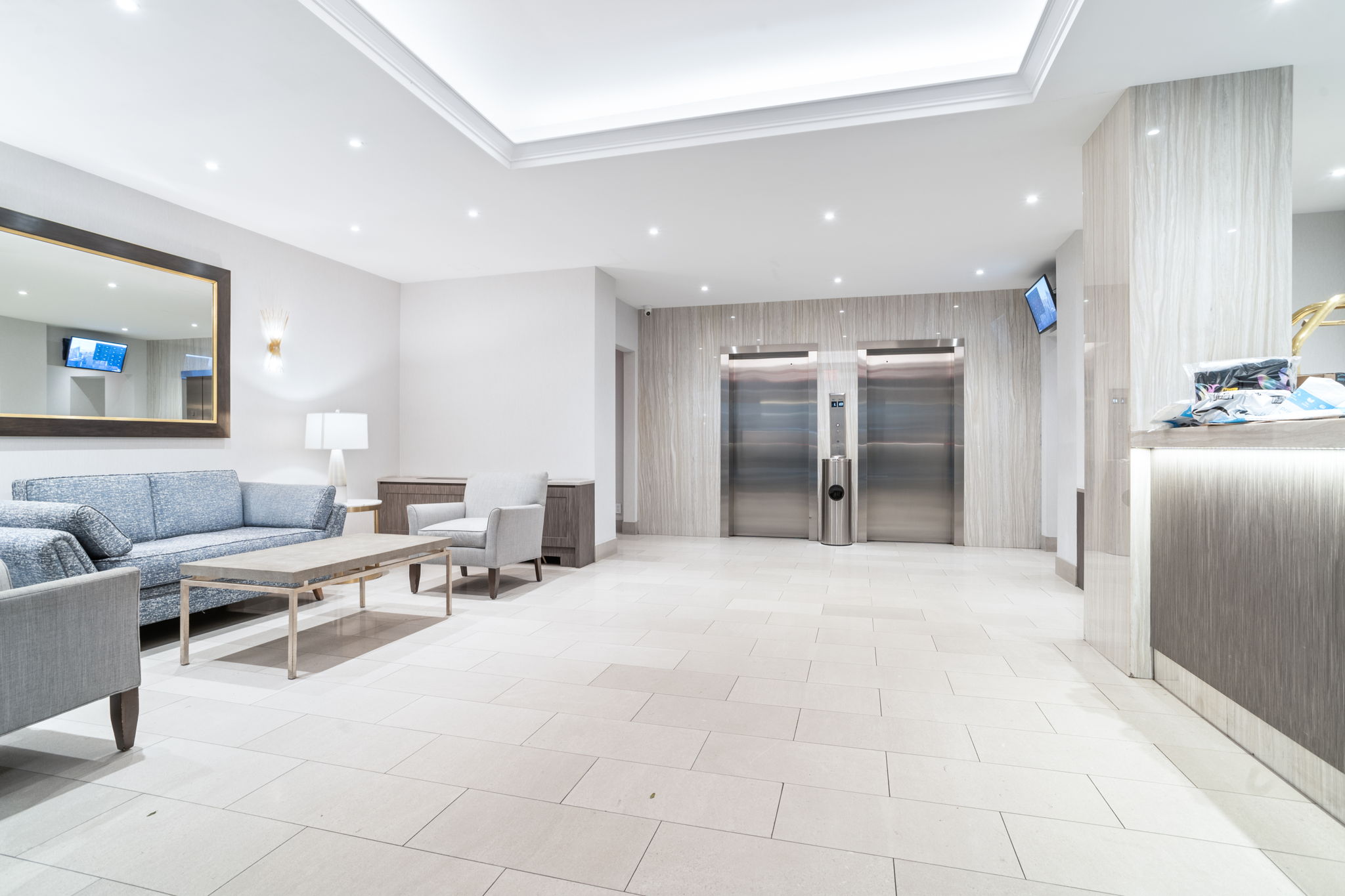 401 East 65th Street, Unit 12F Manhattan, NY 10065 - Photo 16 of 18 a living room with furniture and a large mirror