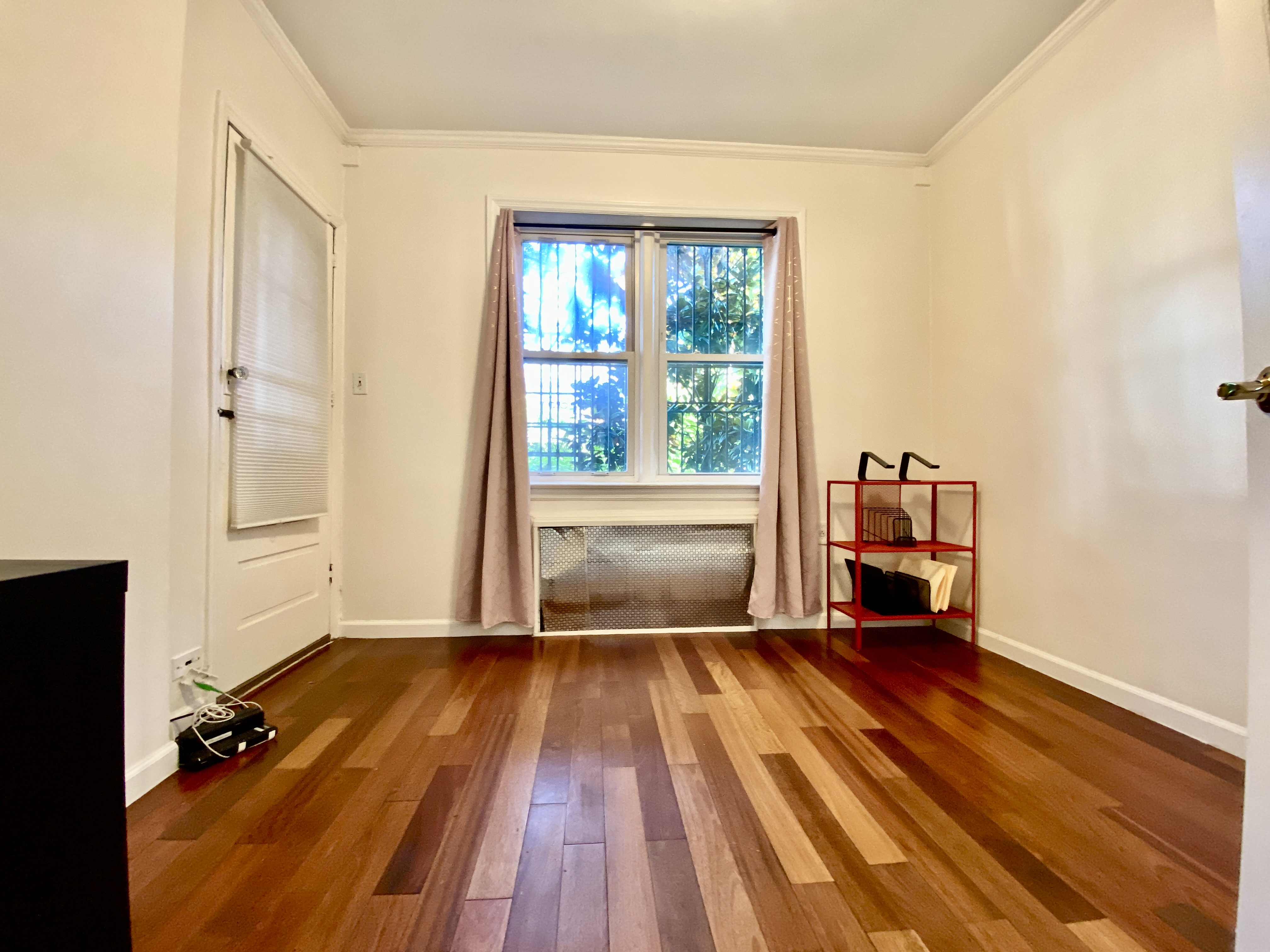 156 96th Street, Unit 1 Brooklyn, NY 11209 - Photo 4 of 7 an empty room with wooden floor and windows