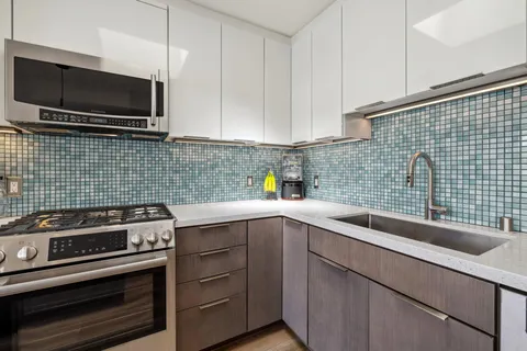 a living room with furniture a window and a potted plant