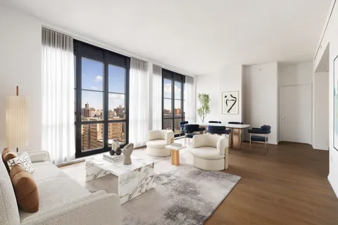 a living room with furniture and large windows