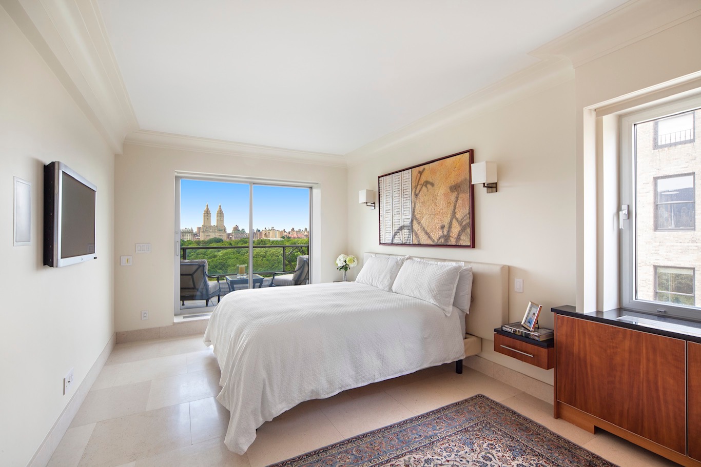 923 5th Avenue, Unit 15A Manhattan, NY 10021 - Photo 3 of 10 a bedroom with a large bed and a window
