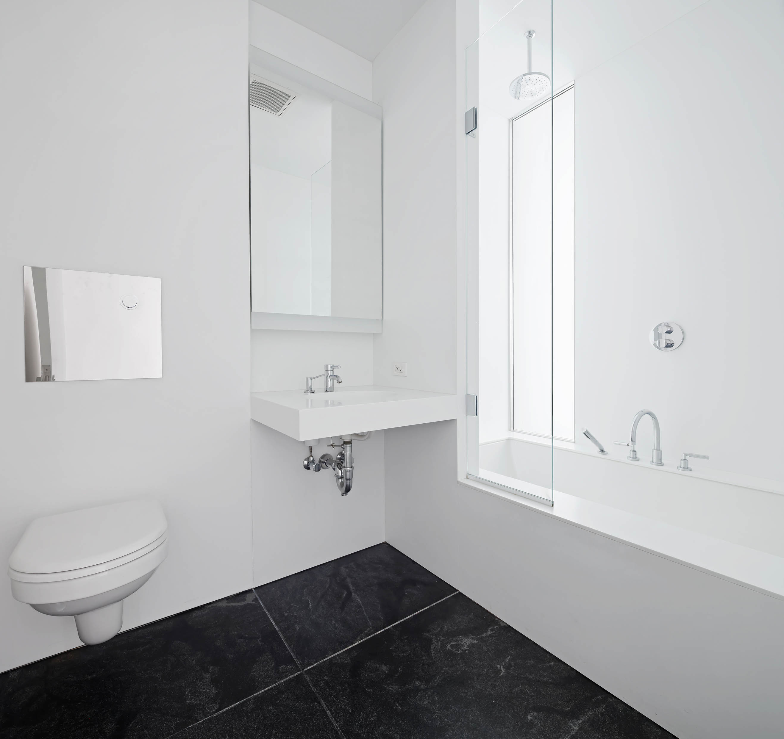 165 Charles Street, Unit 14 Manhattan, NY 10014 - Photo 11 of 18 a bathroom with a sink toilet and vanity