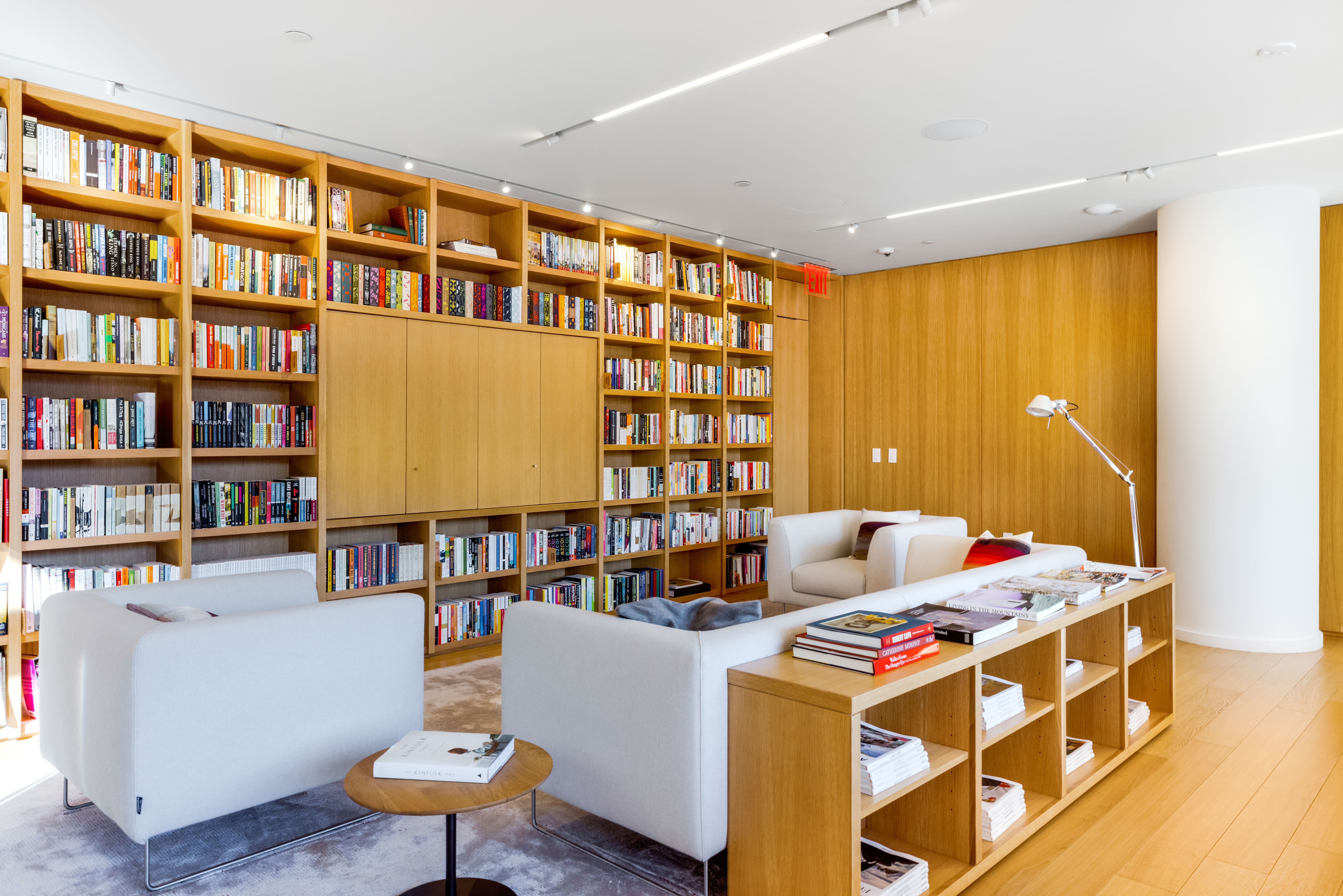 565 Broome Street, Unit N11D Manhattan, NY 10013 - Photo 14 of 18 a living room with fireplace furniture and a book shelf