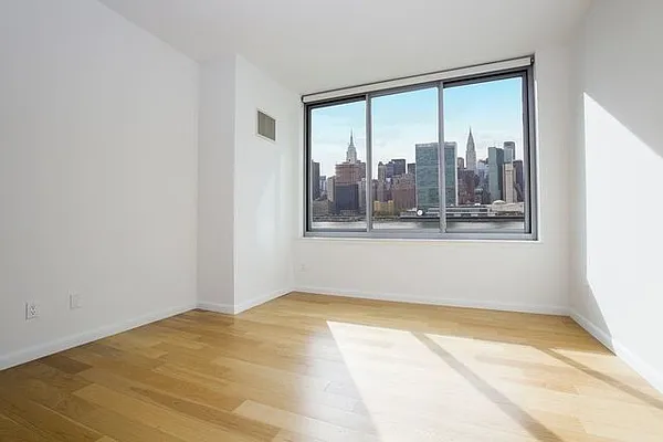 46-30 Center Boulevard, Unit 1209 Queens, NY 11109 - Photo 9 of 26 a view of a room with a large window