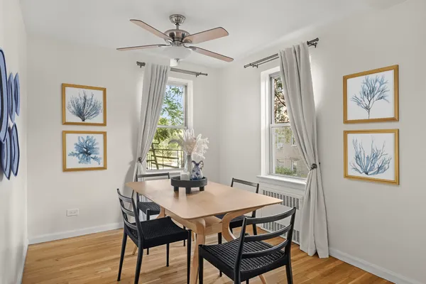 a view of a dining room with furniture window and wooden floor