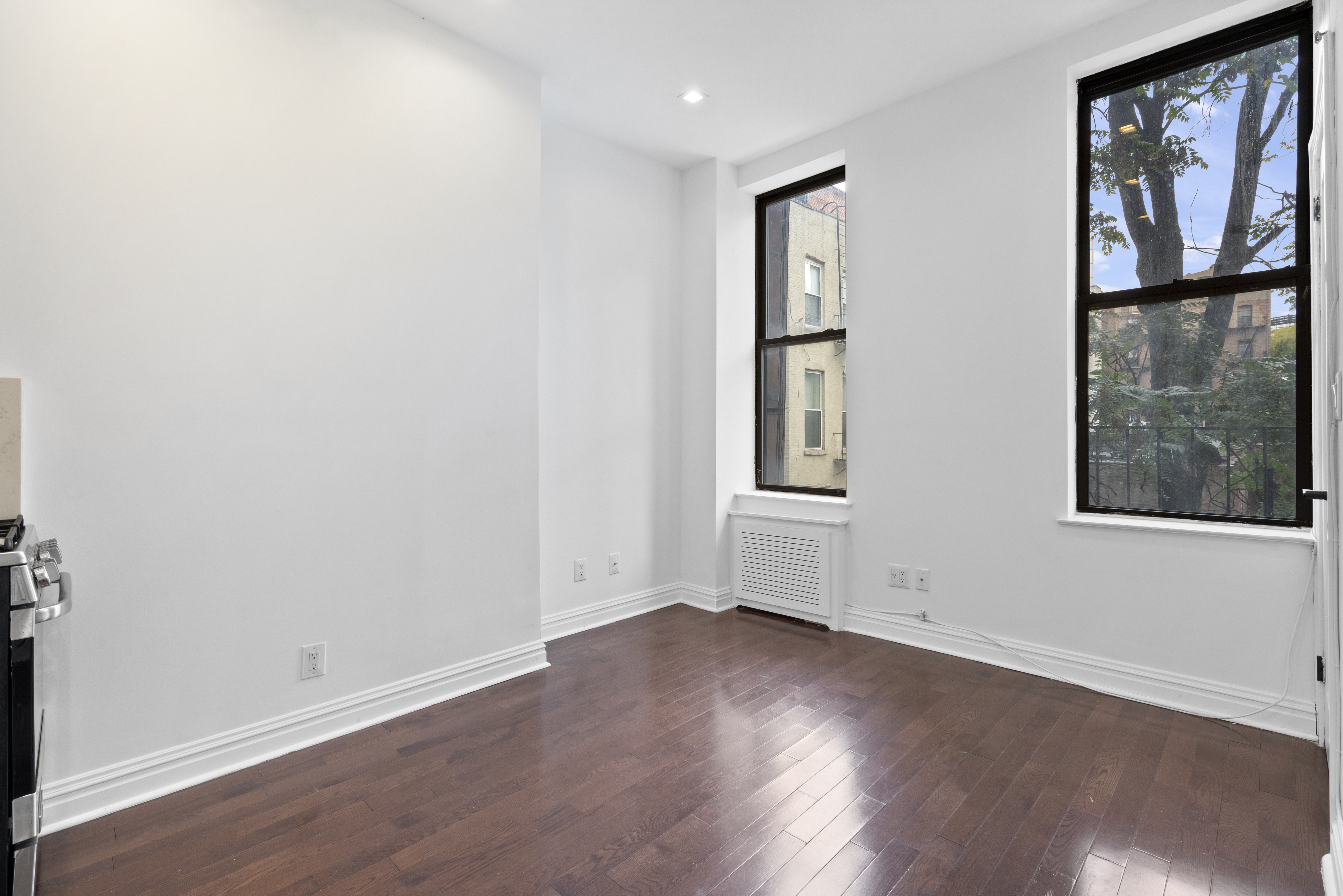 31 St Marks Place, Unit 4 Manhattan, NY 10003 - Photo 2 of 11 a view of an empty room with wooden floor and a window