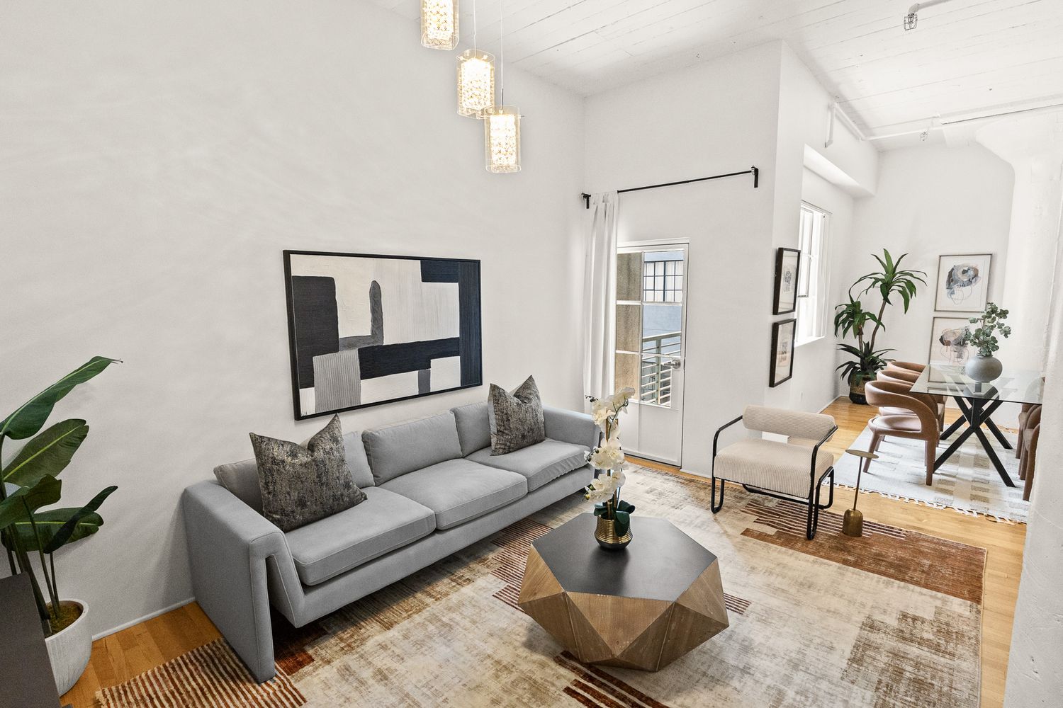 a very nice looking room with wooden floor and furniture
