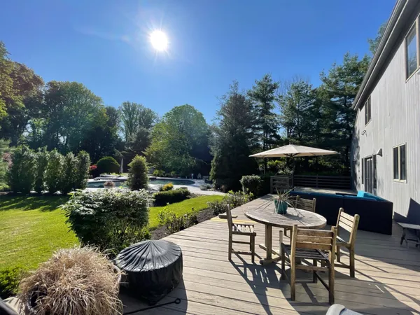 a view of a patio with furniture and garden
