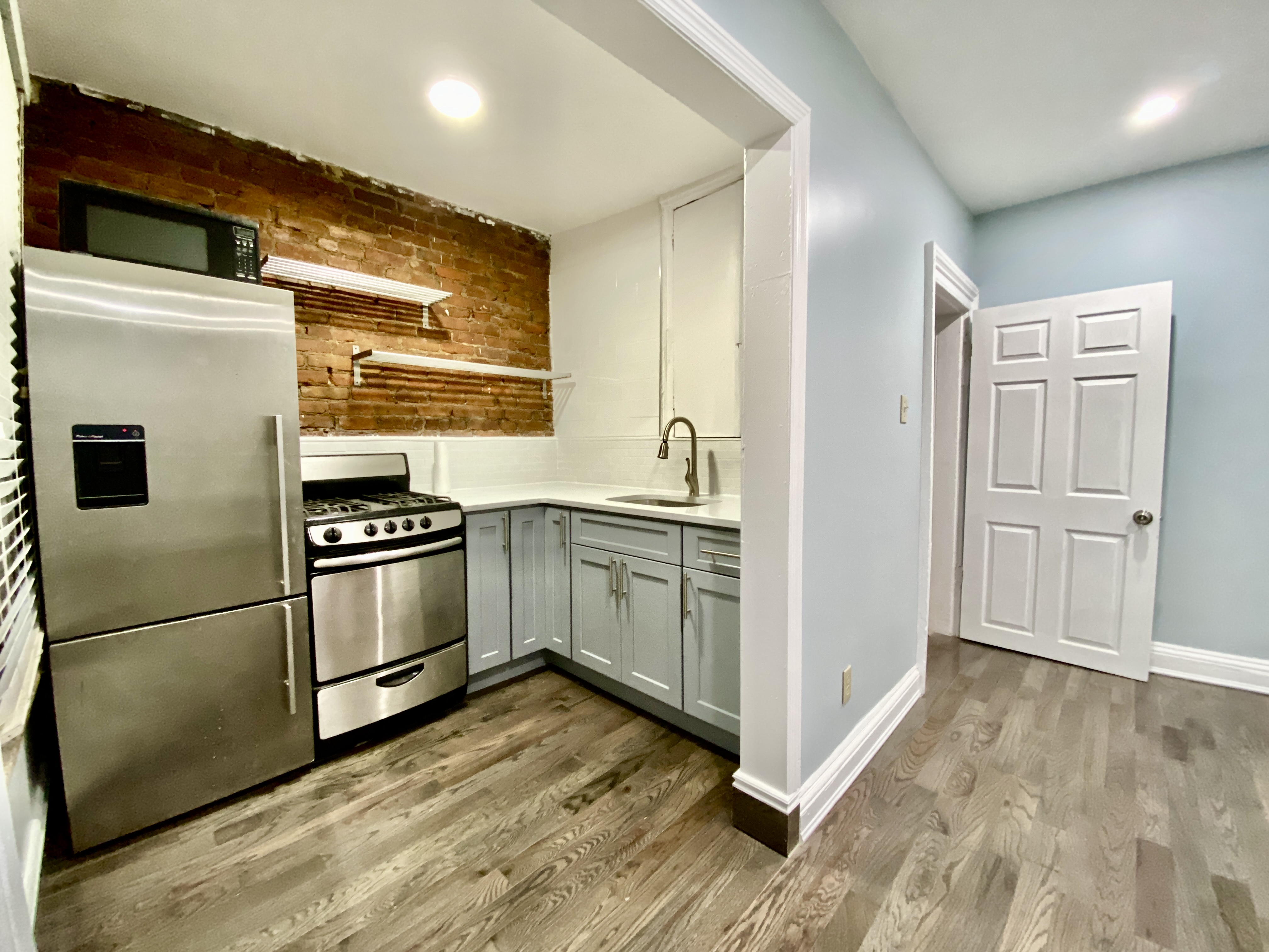398 Decatur Street, Unit 3 Brooklyn, NY 11233 - Photo 3 of 9 a kitchen with stainless steel appliances a refrigerator sink and cabinets