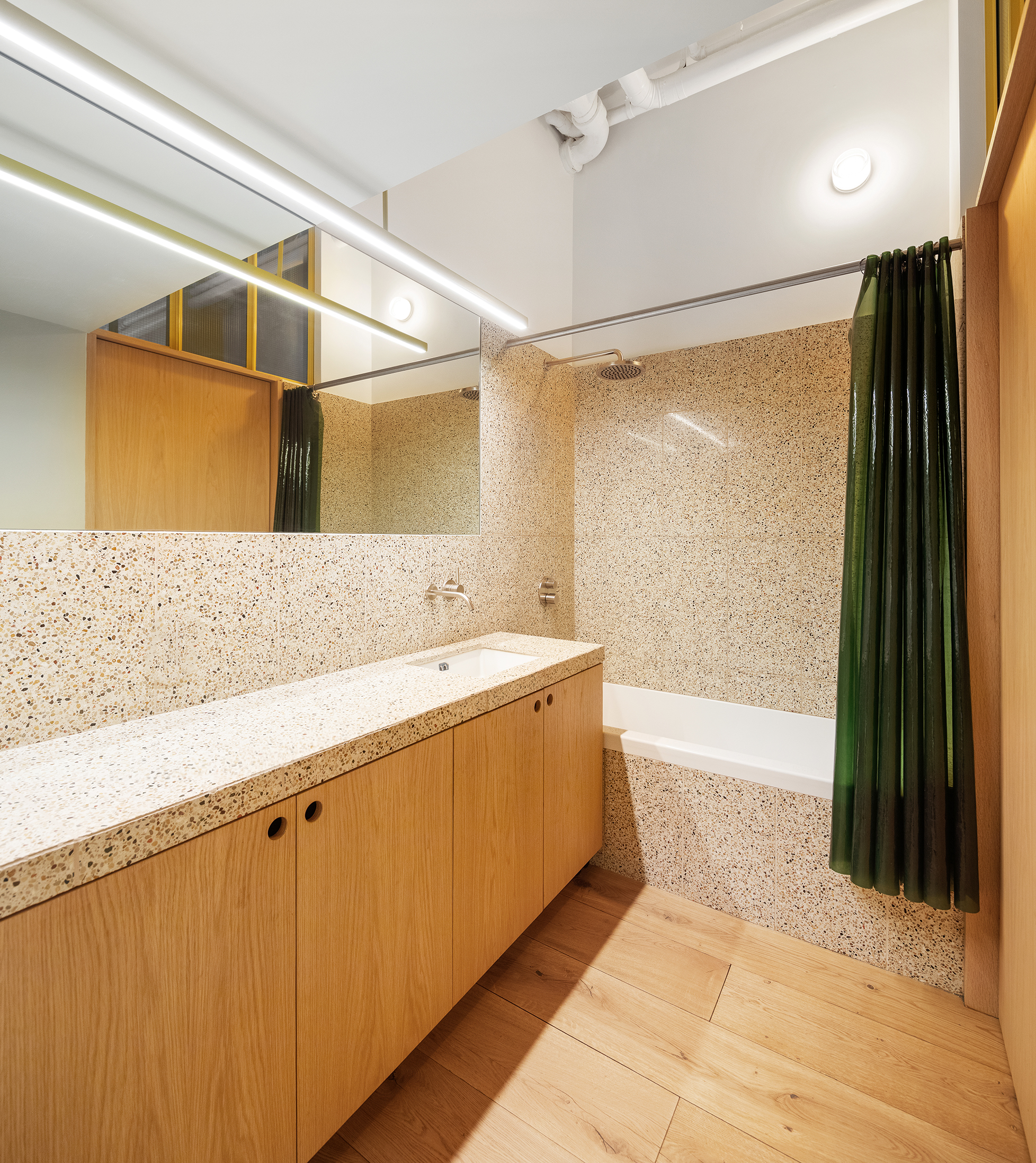 140 Sullivan Street, Unit 1FR Manhattan, NY 10012 - Photo 13 of 19 a bathroom with a sink mirror and a bathtub