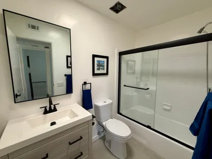a bathroom with a sink mirror vanity and toilet
