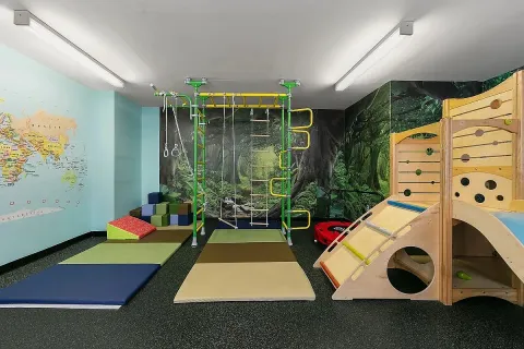 a room with pool table and paintings on the wall