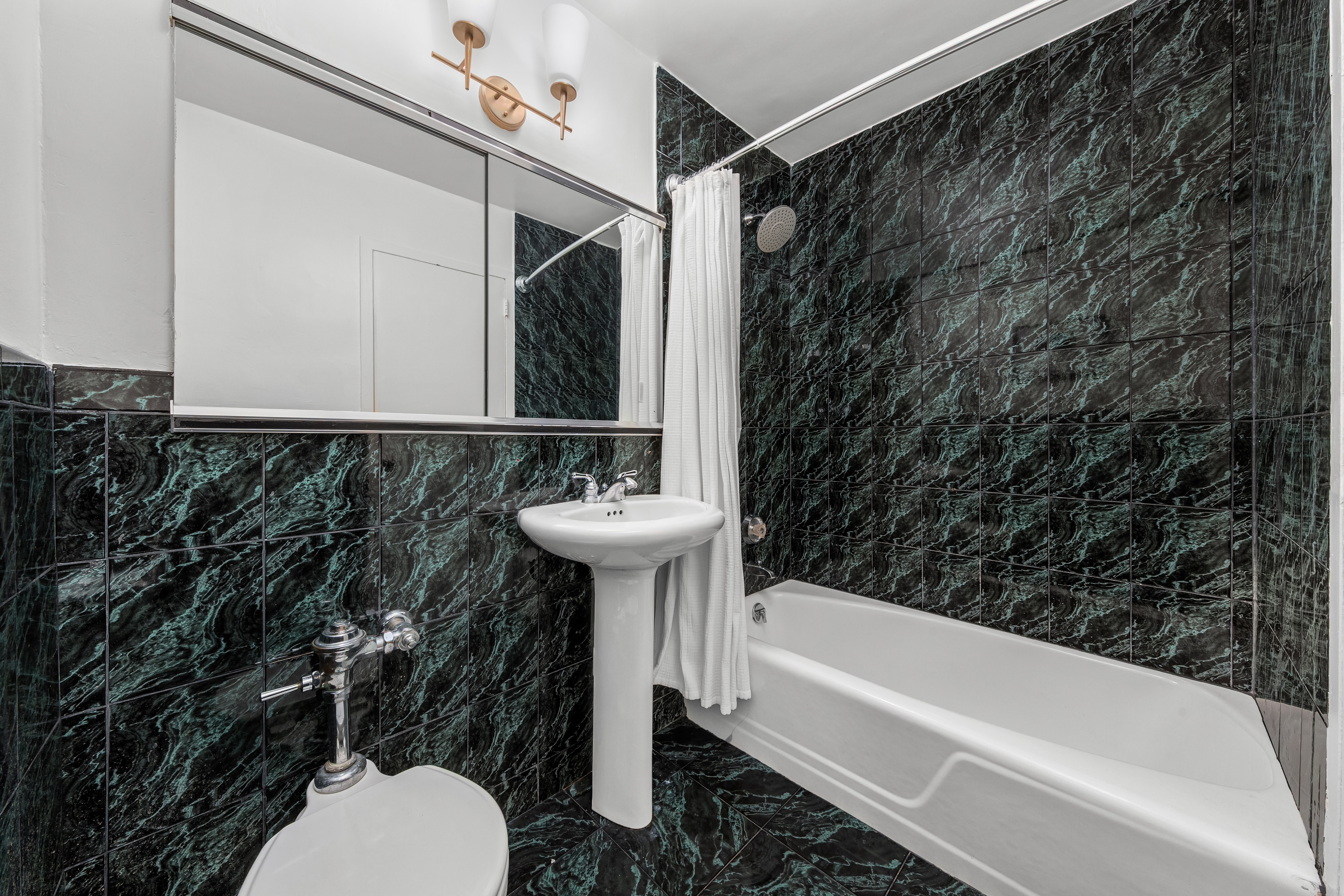 1160 3rd Avenue, Unit 12C Manhattan, NY 10065 - Photo 5 of 6 a bathroom with a sink a toilet and bathtub
