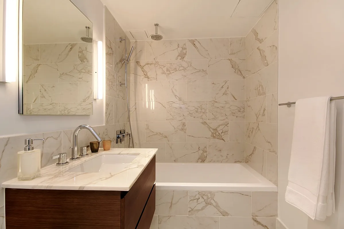 325 Lexington Avenue, Unit 10D Manhattan, NY 10016 - Photo 7 of 16 a bathroom with a granite countertop sink a toilet and bathtub