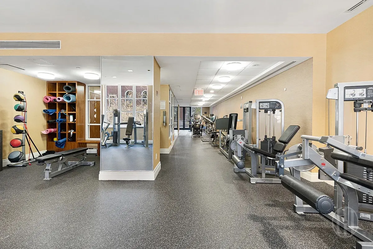 a living room with lots of furniture and gym equipment