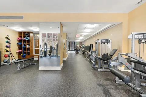 a living room with lots of furniture and gym equipment