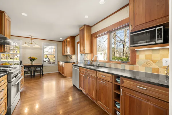 a kitchen with stainless steel appliances granite countertop a stove and a refrigerator