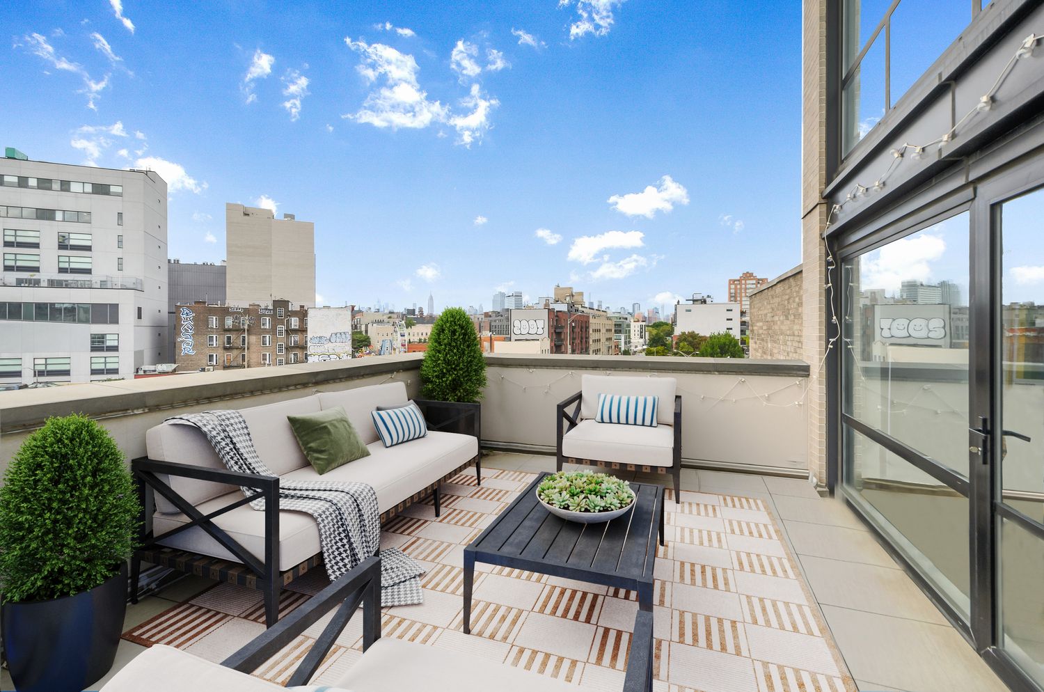 476 Union Avenue, Unit PH5A Brooklyn, NY 11211 - Photo 15 of 17 a balcony with furniture and a potted plant