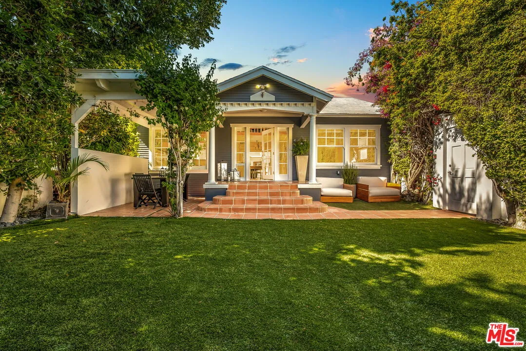 a front view of a house with a garden