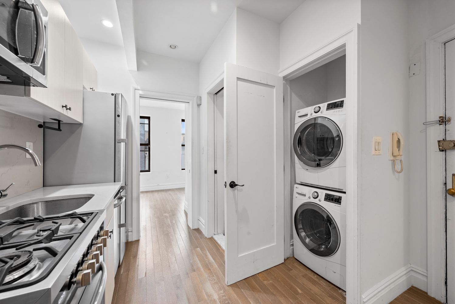 142 Sullivan Street, Unit 14 Manhattan, NY 10012 - Photo 3 of 10 a view of a kitchen with washer and dryer