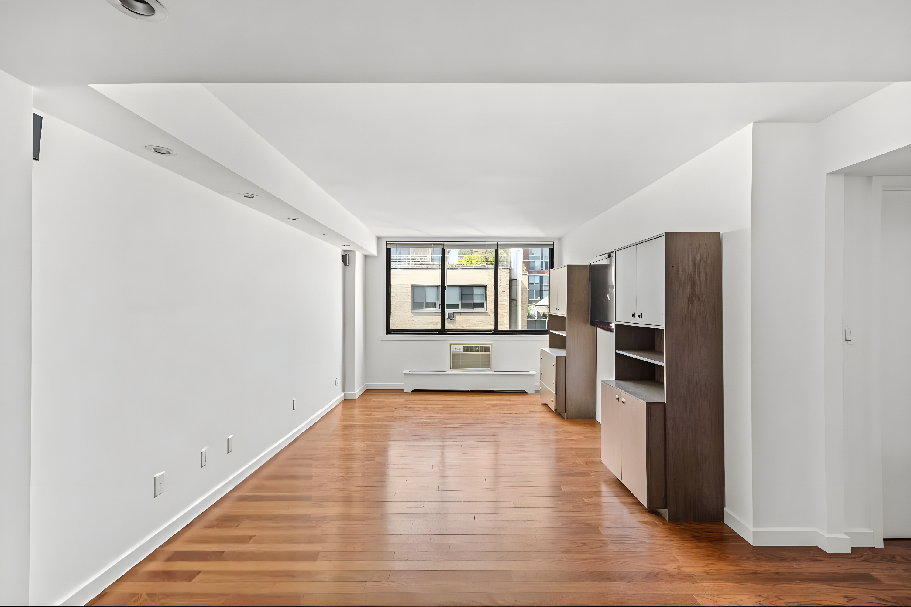 16 West 16th Street, Unit 14NN Manhattan, NY 10011 - Photo 1 of 10 a view of a kitchen with refrigerator and wooden floor