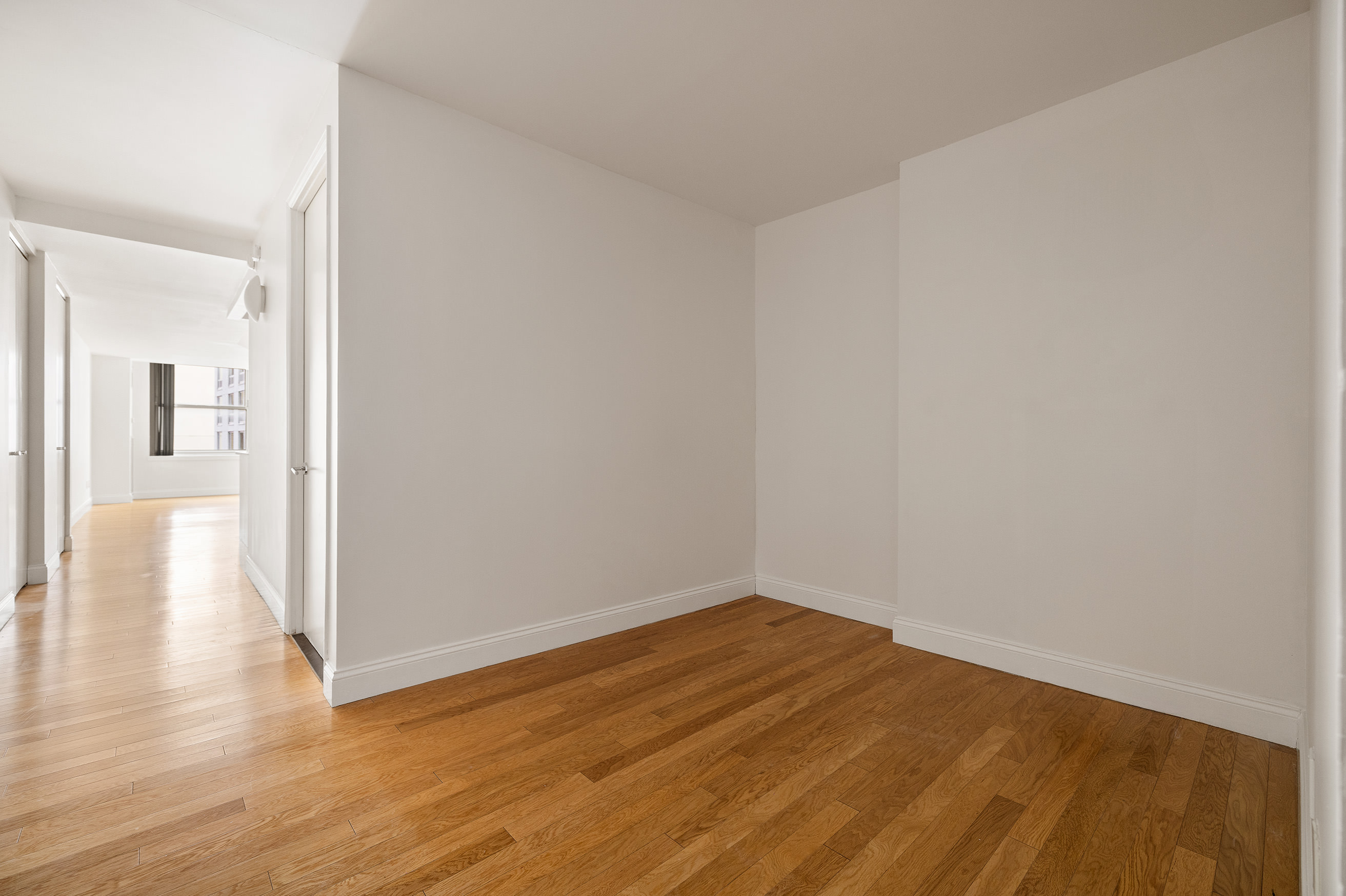 88 Greenwich Street, Unit 1014 Manhattan, NY 10006 - Photo 7 of 14 a view of a room with wooden floor