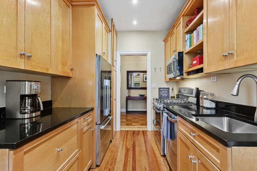 125 Cabrini Boulevard, Unit A52 Manhattan, NY 10033 - Photo 9 of 20 a kitchen with stainless steel appliances a sink stove and refrigerator
