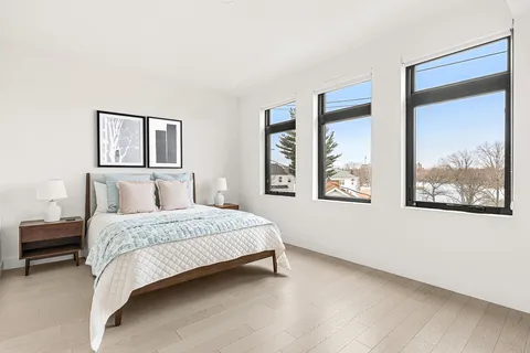 a bedroom with a large bed and a window