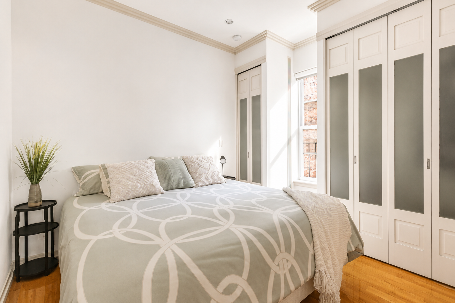 345 West 70th Street, Unit 4E Manhattan, NY 10023 - Photo 6 of 11 a bed sitting in a bedroom next to a window