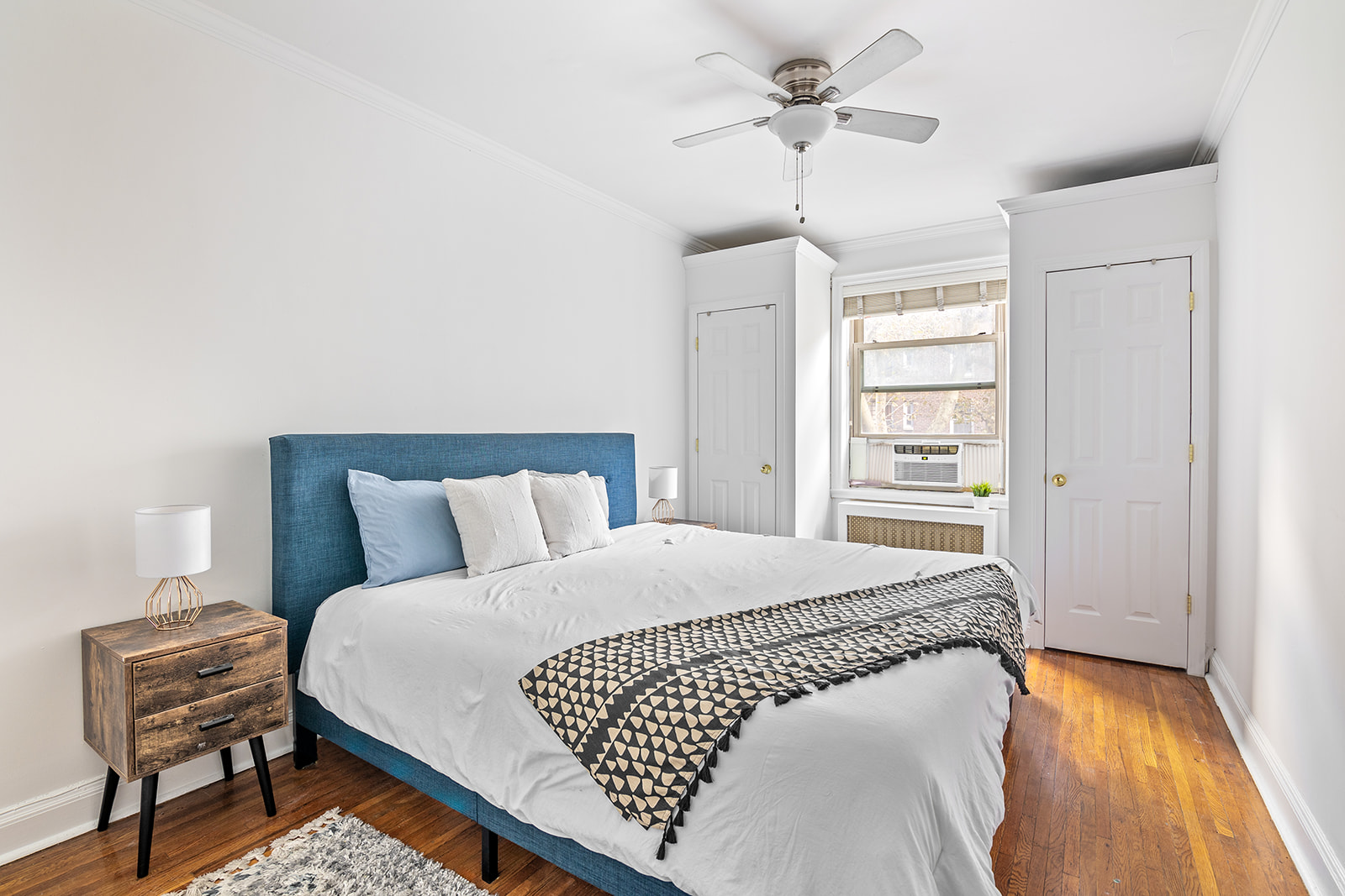 48-19 43rd Street, Unit 4A Queens, NY 11377 - Photo 2 of 8 a bedroom with a bed and a dresser with rug