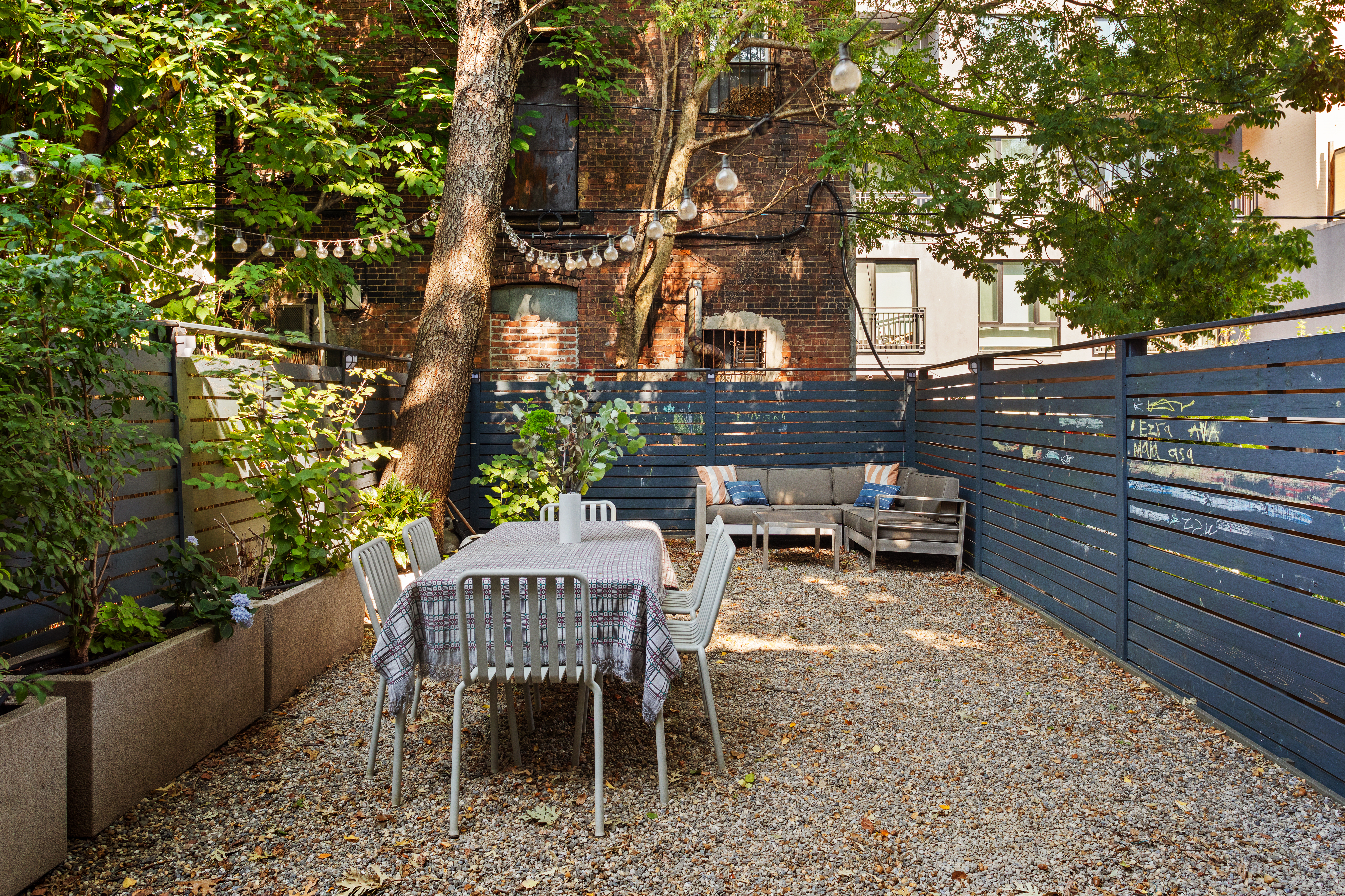 197 Madison Street Brooklyn, NY 11216 - Photo 17 of 19 a view of a chairs and table in the back yard