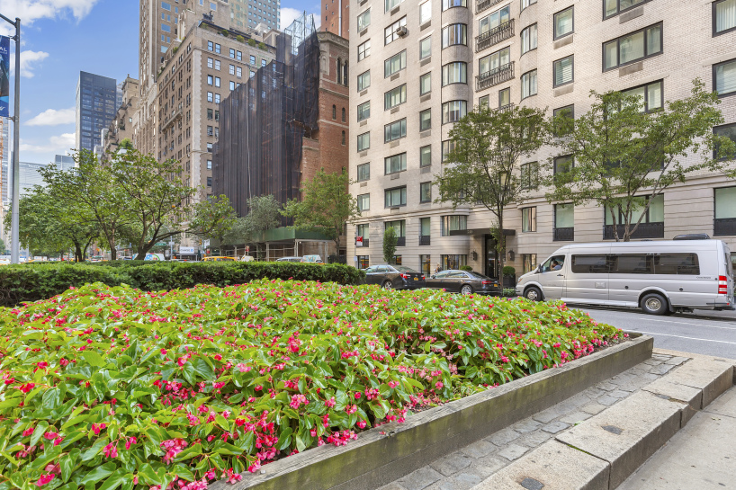 530 Park Avenue, Unit 4A Manhattan, NY 10065 - Photo 14 of 16 a view of a building and yard with beautiful flowers