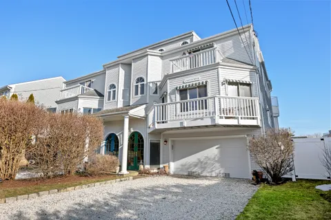 a view of a house with swimming pool and sitting area