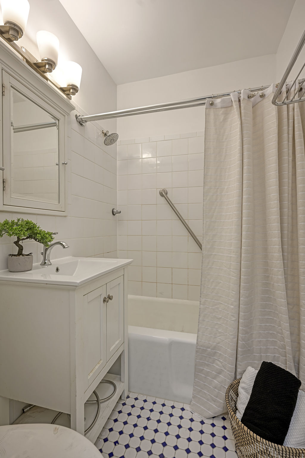 300 East 74th Street, Unit 6D Manhattan, NY 10021 - Photo 11 of 12 a bathroom with a bathtub and a shower